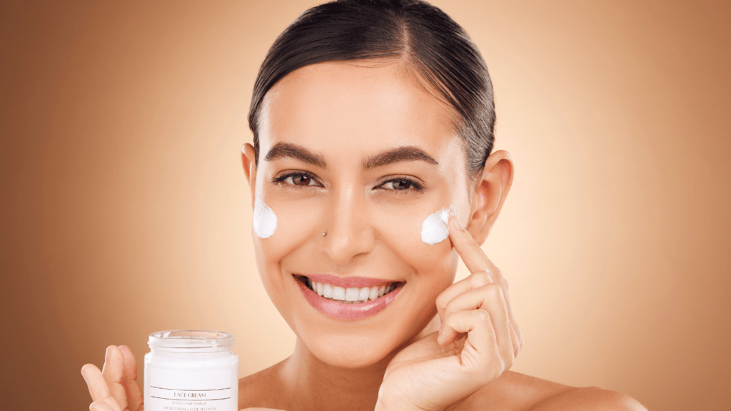 Woman putting face cream in the morning 