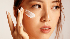 Woman applying face cream