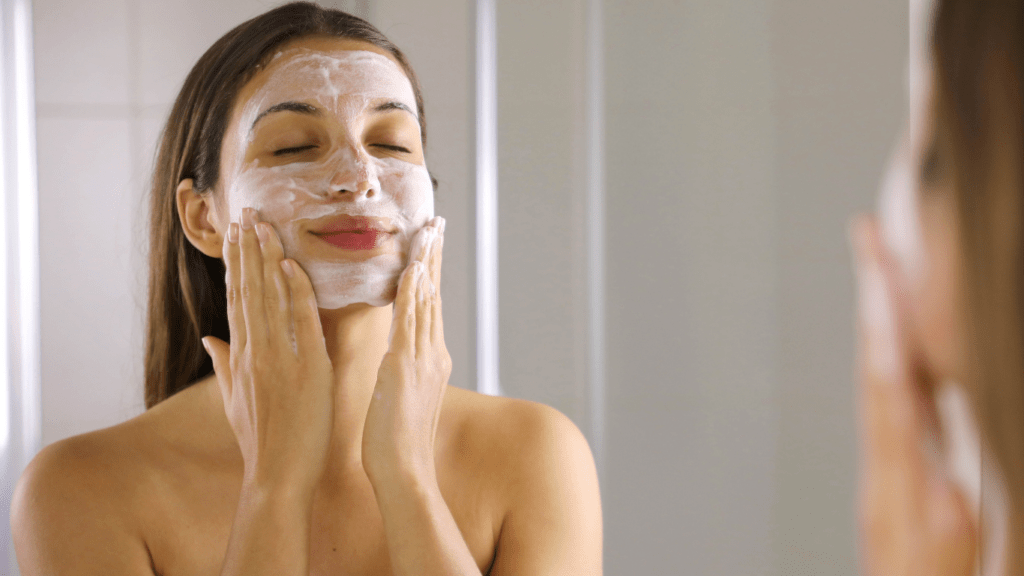 Woman cleansing her face